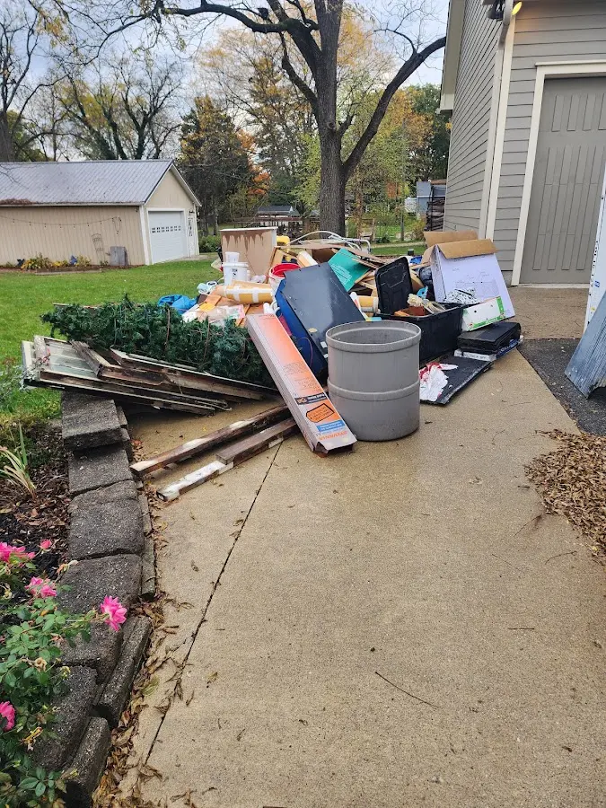 Dumpster being loaded with debris for Estate Cleanout Dumpster Rental in Anoka